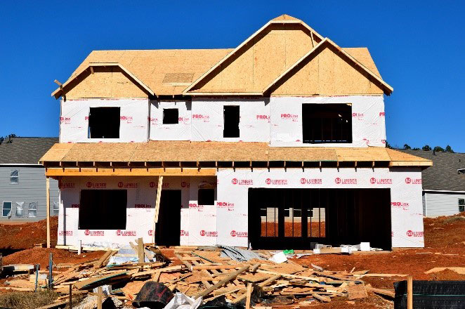 House under construction with double garage doors